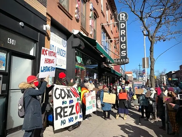 Protesters hold signs on a Gowanus sidewalk during a legal challenge to the rezoning.