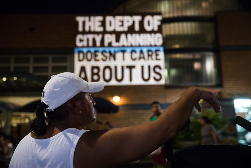 Nighttime projection with anti-displacement message on building or public surface near Myrtle-Wyckoff.